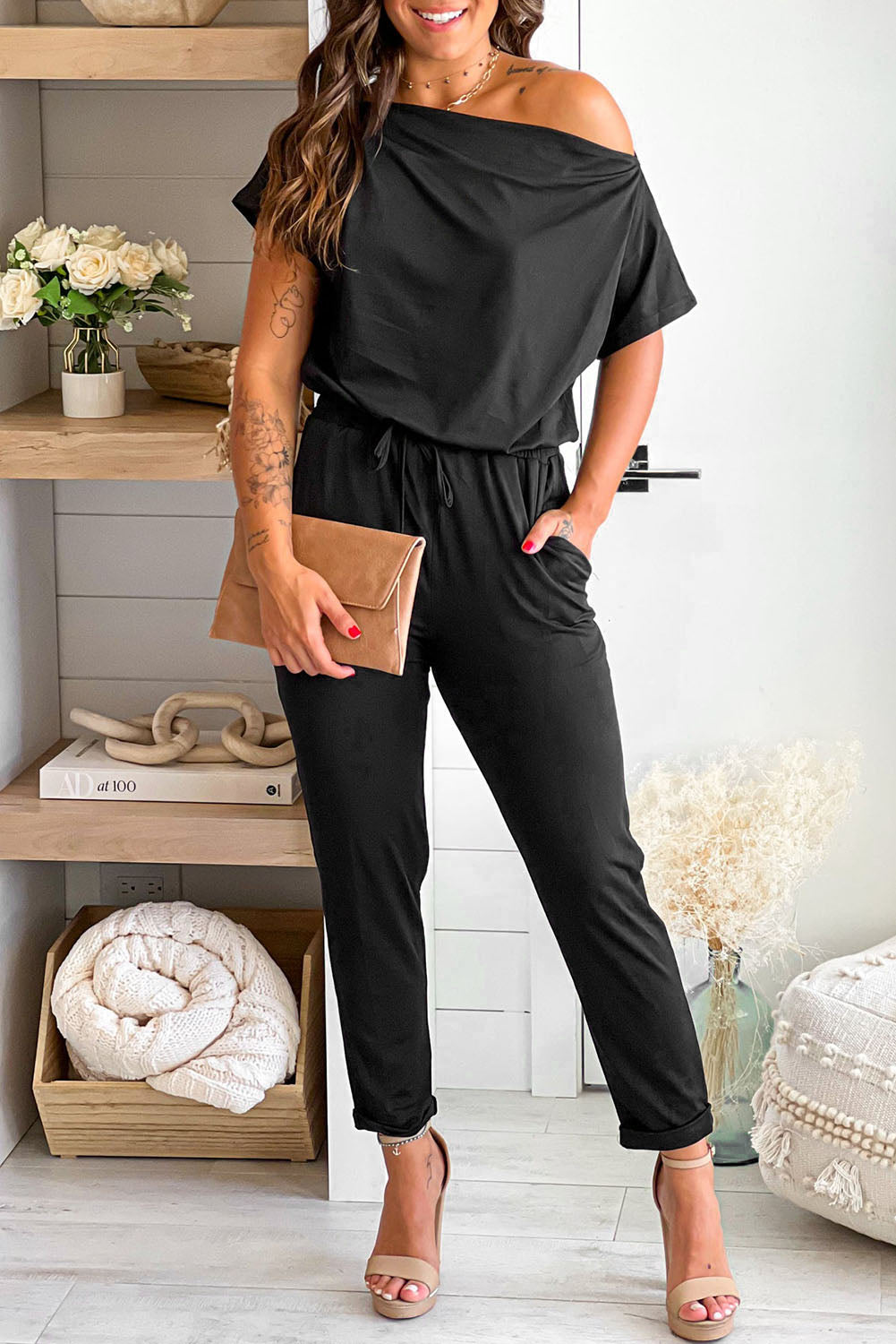 Black Tie Waist Off Shoulder Short Sleeve Tapered JumpsuitMaterial:90%Polyester+10%Elastane


	


		The short sleeves provide coverage while still allowing for ease of movement, and the tapered legs create a sleek and s