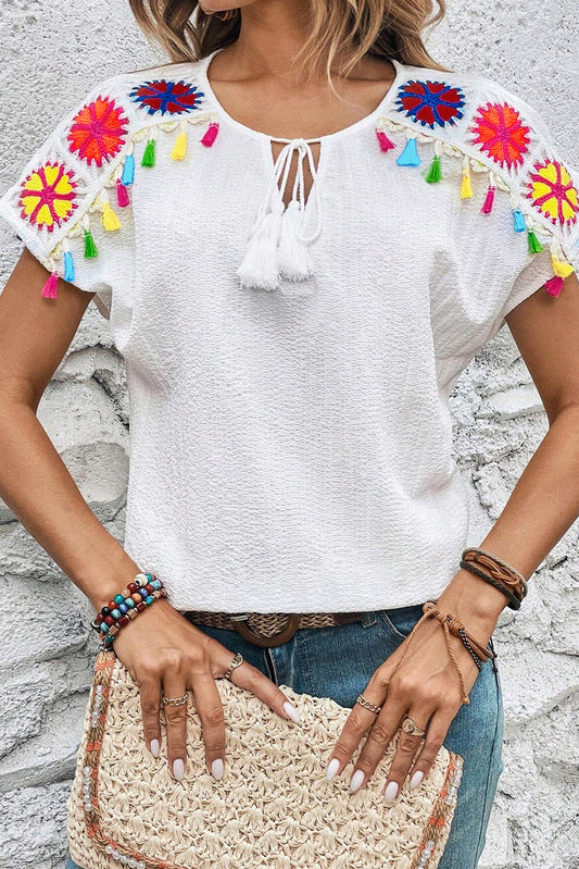 White Boho Embroidered V Neck Fringe Short Sleeve BlouseMaterial:97%Polyester+3%Elastane



		The blouse is crafted from a soft and breathable fabric, providing comfort and allowing for easy movement.
	
	
		This blou