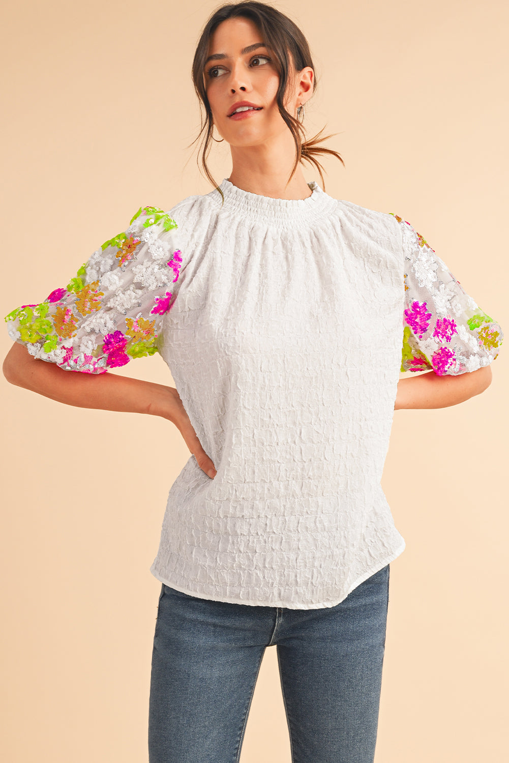 White Smocked Neck Sequin Flower Puff Sleeve Textured TopMaterial:100%Polyester



		The Top features a smocked neckline and sequin flower embellishments for a feminine and glamorous look.
	
	
		With its puff sleeves,