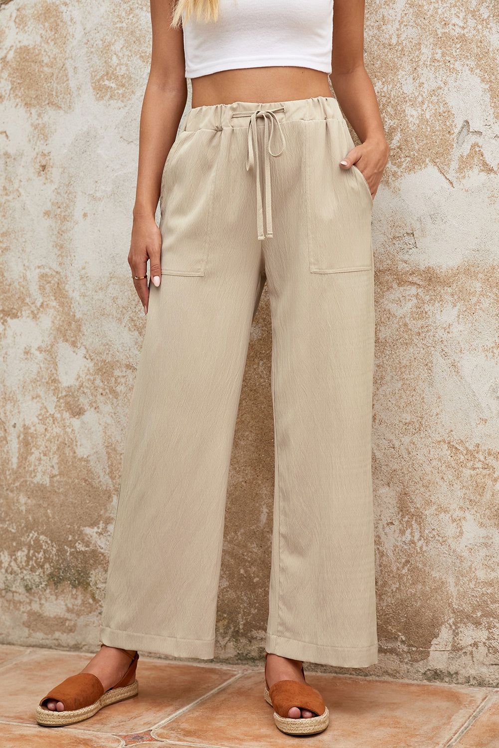 Khaki Drawstring Waist Crinkled Wide Leg PantsMaterial:100%Polyester



		Solid color pants are classic and chic, a must-have in girl's and woman's wardrobe
	
	
		You can wear the wide-leg pants for a laid 