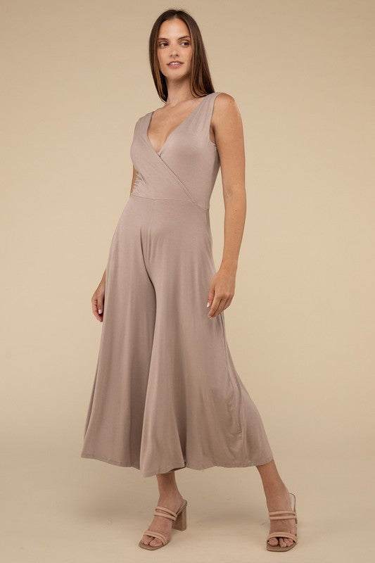 Surplice Neckline Sleeveless JumpsuitThe Surplice Neckline Sleeveless Jumpsuit exudes effortless elegance and modern sophistication. Featuring a surplice neckline, this jumpsuit offers a chic and flatte