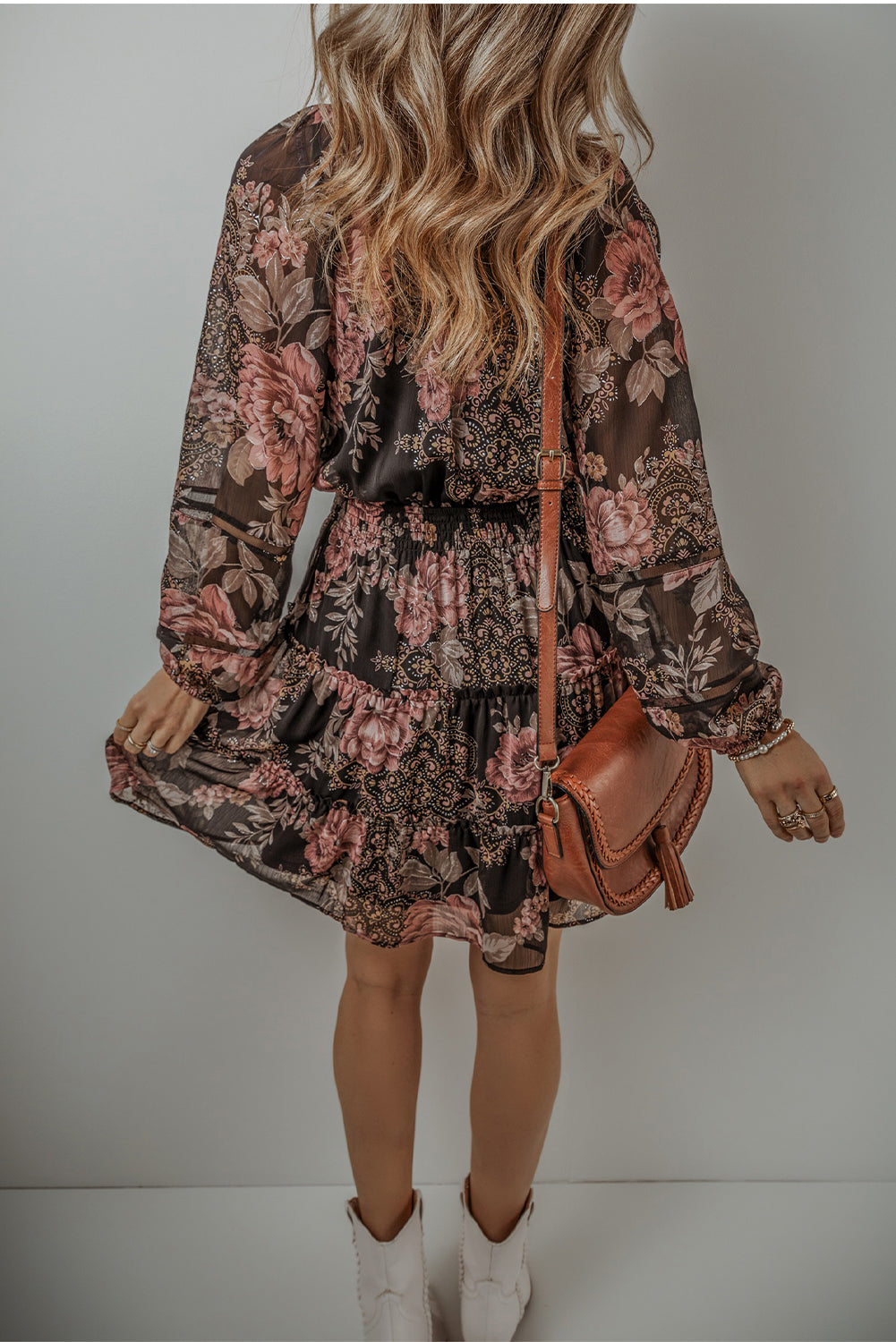 Black Floral Puff Sleeve V Neck Smocked Waist Mini DressMaterial:100%Polyester

• Embrace the essence of bohemian style with this dress, featuring a charming floral print that adds a touch of femininity.
• The V-necklin