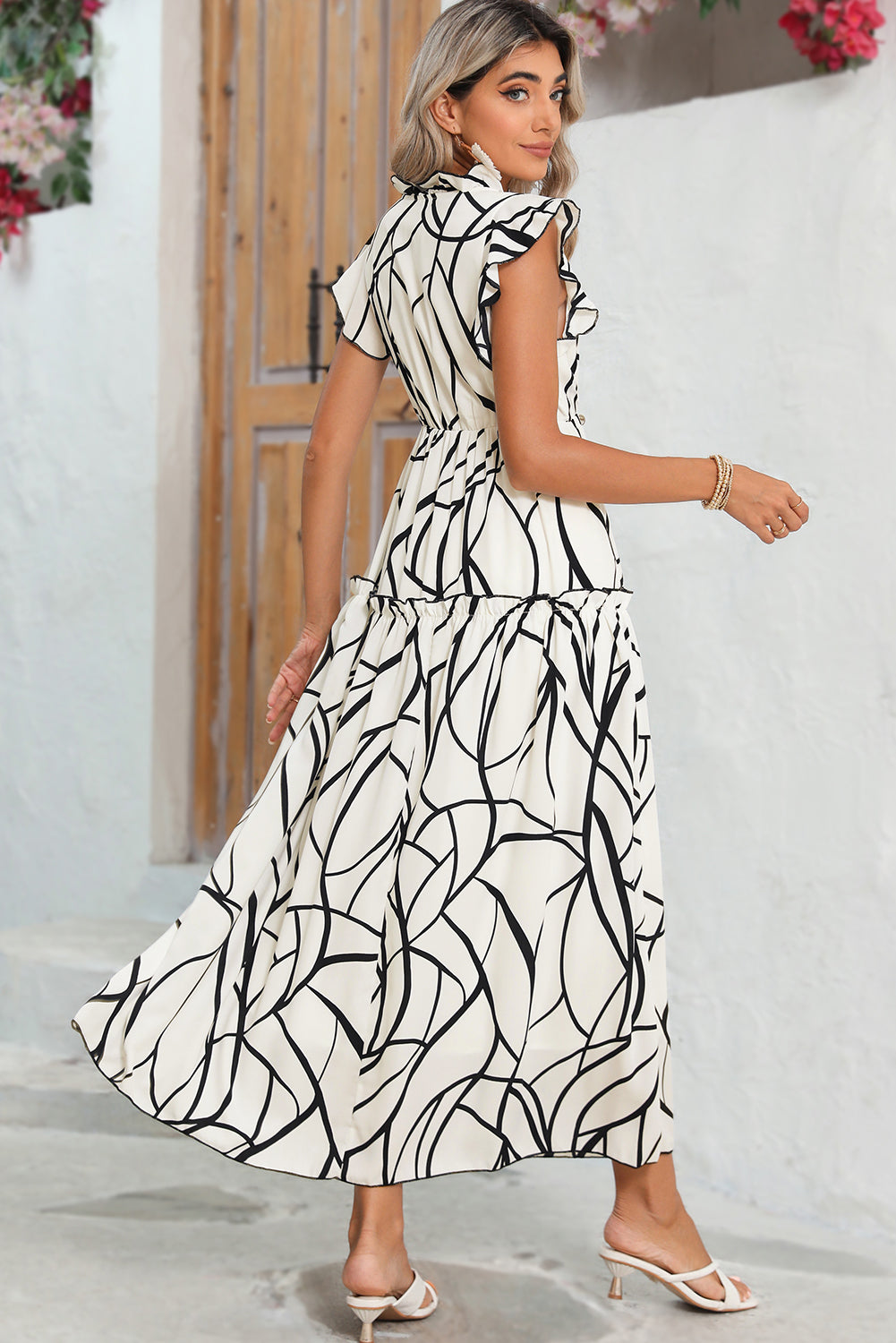 White Abstract Print V Neck Ruffle Maxi DressMaterial:100%Polyester



		The dress has a V-neckline, which adds a touch of femininity to the overall look. 
	
	
		It also has ruffle details on the shoulders