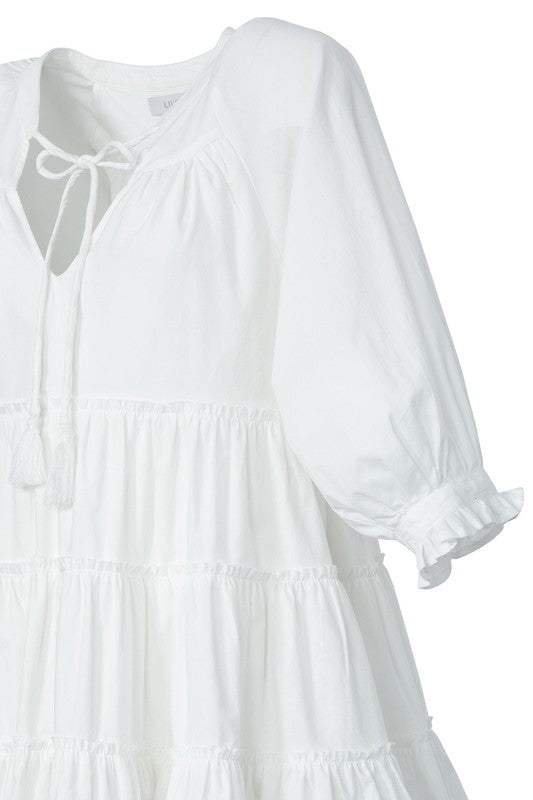 Tiered mini dress with tassel- Tiered mini dress with tassel- Pattern type : solid- Neck line : V neck- Sleeve type : raglan sleeves- Sleeve length : 3/4 sleeves- Stretch : no stretch- Sheer : l