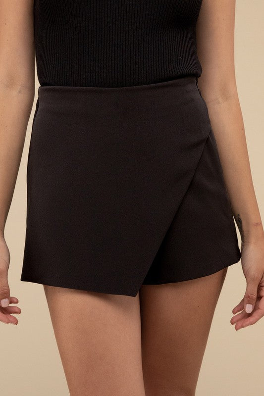 High Waist Asymmetrical SkortIntroducing our High Waist Asymmetrical Skort, a chic and versatile addition to your wardrobe. This skort features an overlapping panel design, giving it a unique as