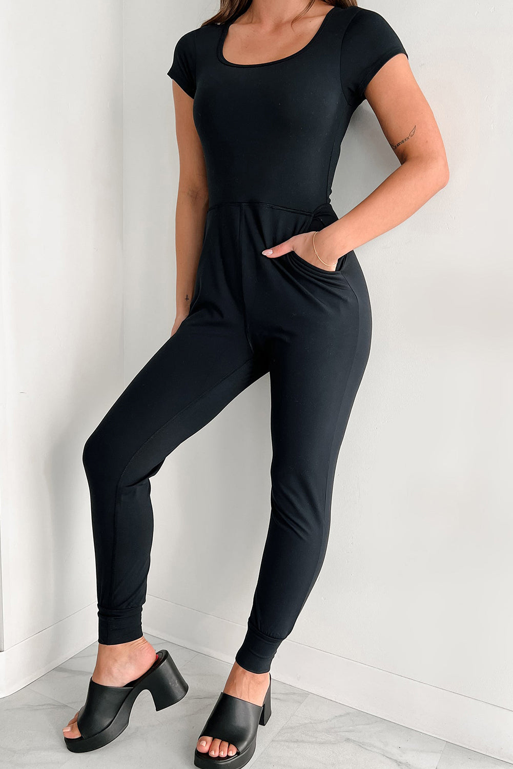 Black Short Sleeve Pocketed Athleisure Jogger JumpsuitMaterial:95%Polyester+5%Elastane



		This black jumpsuit is flattering to show a slim fit figure
	
	
		The round neck, short sleeve and onesies style make it a