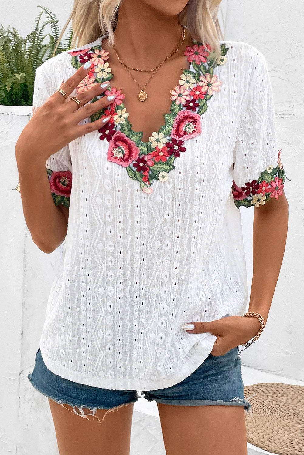 White V-Neck Floral Embroidered Trim Eyelet Blouse• Elevate your summer wardrobe with this blouse featuring intricate Floral Embroidered Trim for a touch of bohemian charm.
• The delicate Eyelet Lace detailing adds