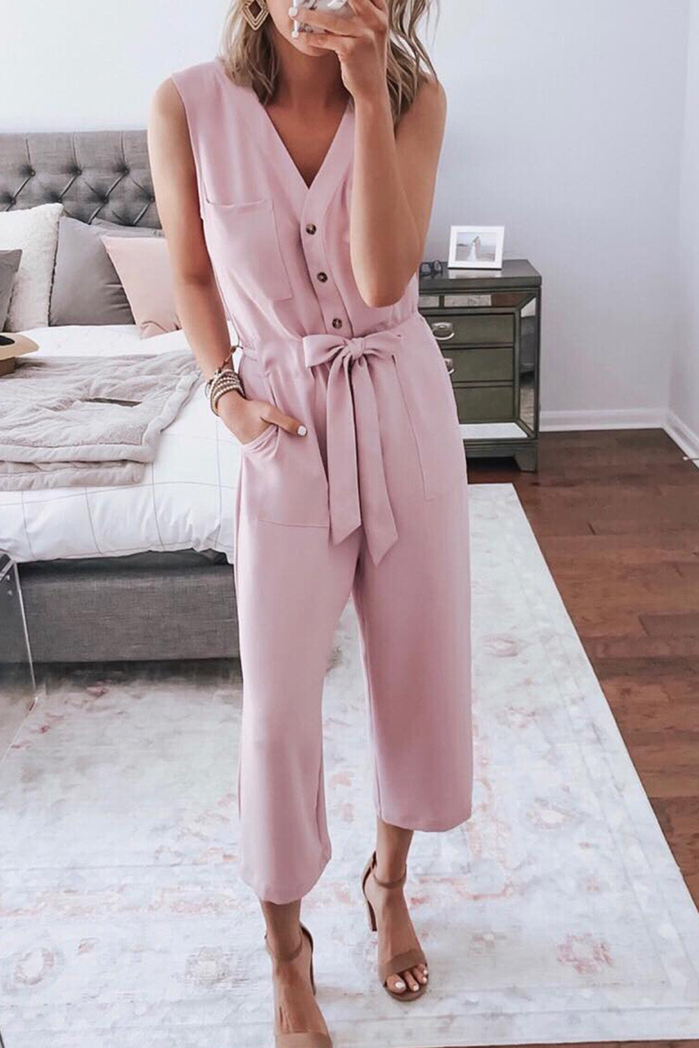 Pink Buttoned Sleeveless Cropped Jumpsuit With SashMaterial:95%POLYESTER+5%ELASTANE



		The
chic jumpsuit features a button-up front and a sleeveless design, making it
perfect for warm weather
	
	
		The
crop