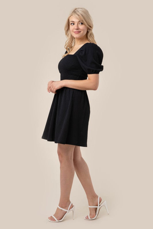 Puff sleeved smocked dress- Puff sleeved smocked dress- Pattern type : solid- Neck line : square neck- Sleeve type : puff sleeves- Sleeve length : short sleeves- Stretch : stretch- Sheer : no