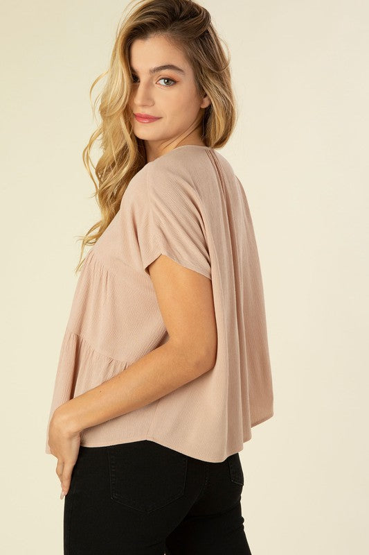 A line tiered blouse- A line tiered blouse- Pattern type : solid- Neck line : round neck when tied, V neck when untied- Sleeve type : dolman short sleeves- Sleeve length : short sleeves