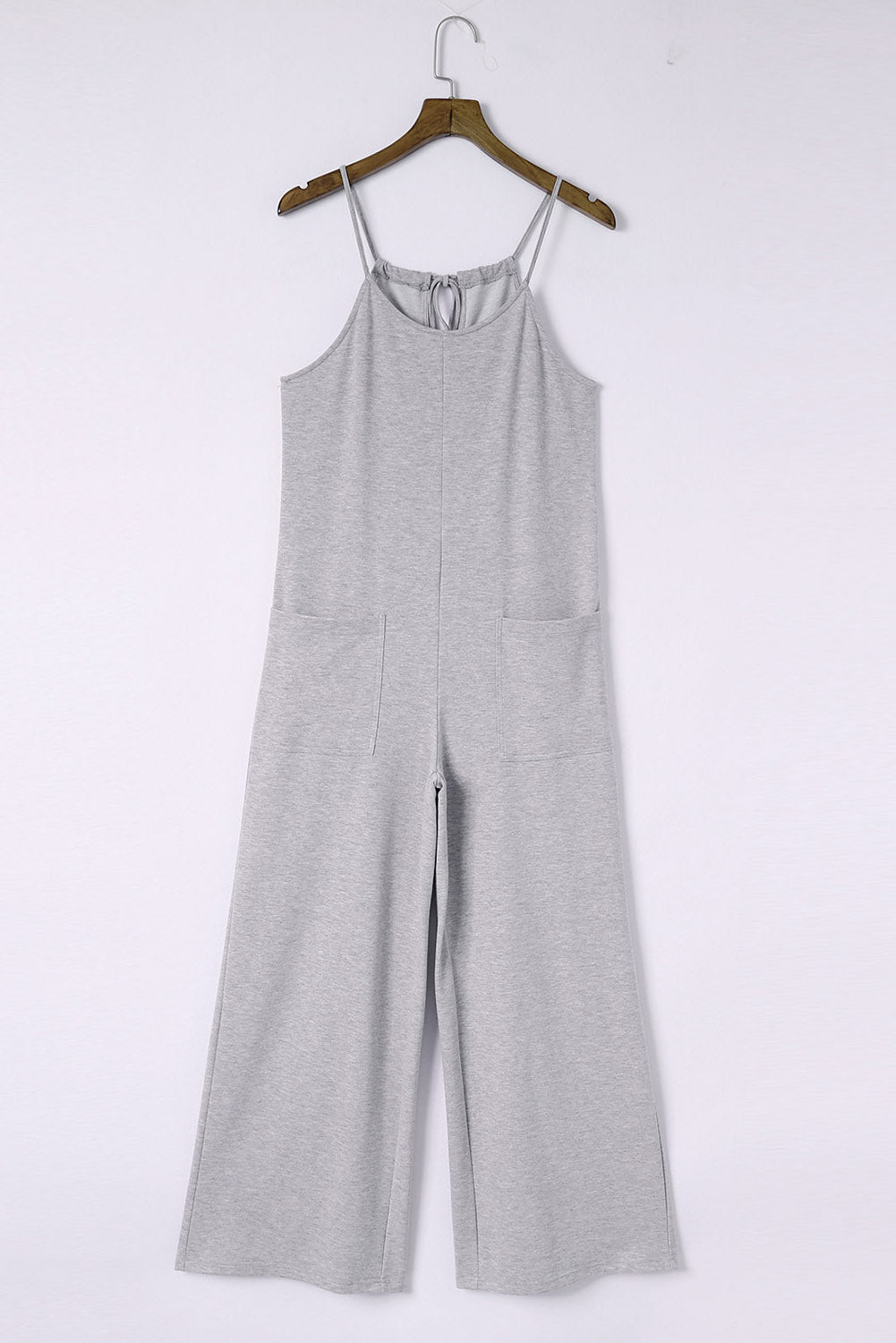 Gray Loose Fit Side Pockets Spaghetti Strap Wide Leg JumpsuitMaterial:65%Polyester+30%Cotton+5%Elastane



		Featuring a loose fit, the wide leg
jumpsuit provides freedom of movement
	
	
		Spaghetti straps highlight wome