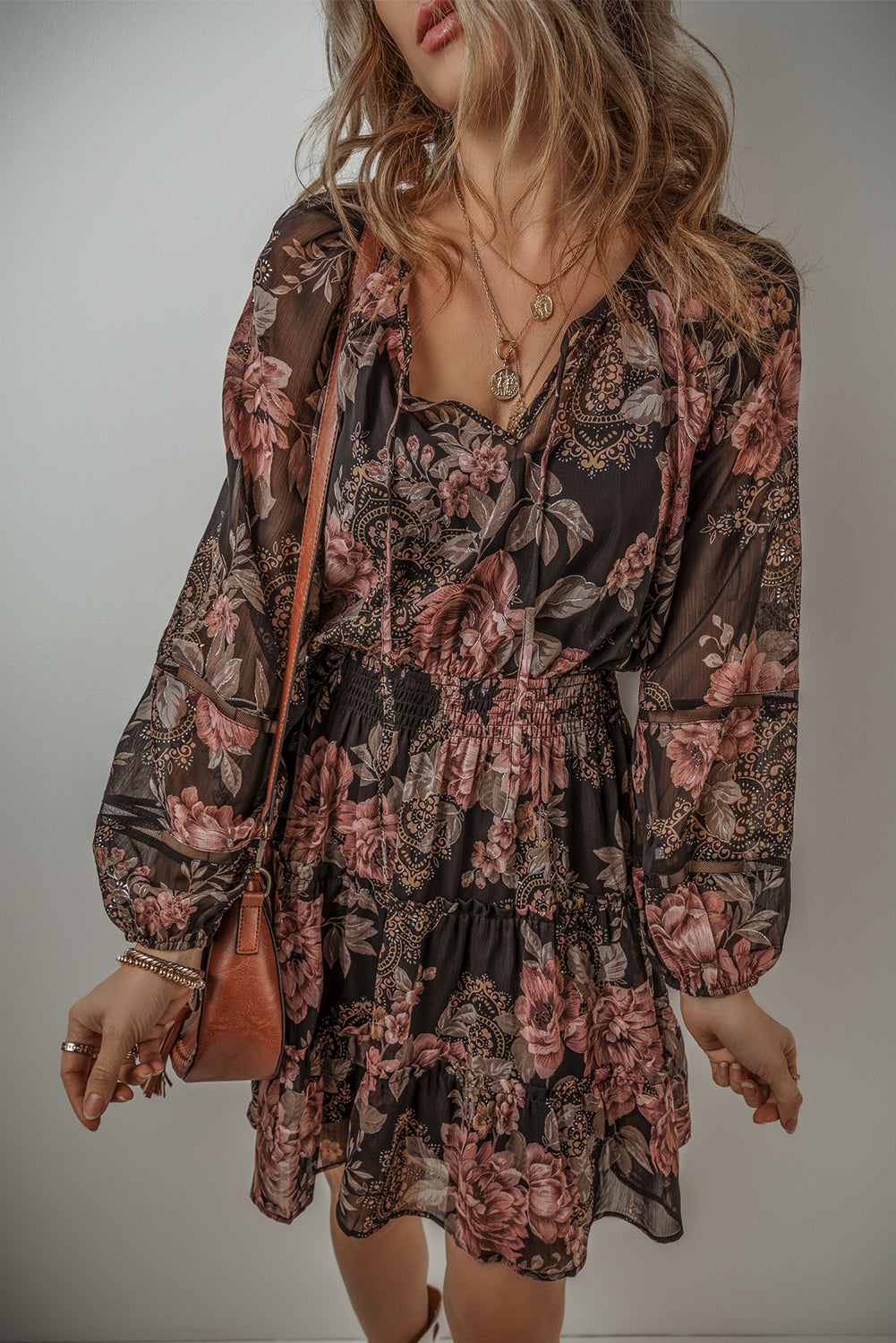 Black Floral Puff Sleeve V Neck Smocked Waist Mini DressMaterial:100%Polyester

• Embrace the essence of bohemian style with this dress, featuring a charming floral print that adds a touch of femininity.
• The V-necklin