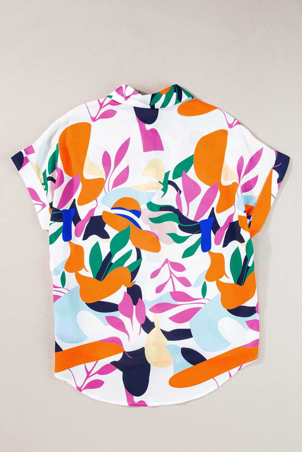 Multicolour Abstract Leaf Print Button Up Short Sleeve BlouseMaterial:100%Polyester

• Infuse your wardrobe with vibrancy in this blouse, perfect for a relaxed yet stylish look.
• The button-up design adds a touch of sophist