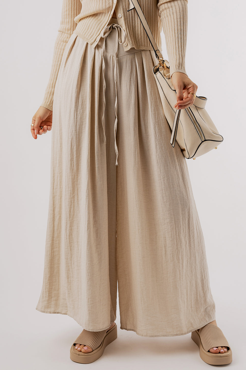 Beige Casual Lace-up Waist Pleated Wide Leg PantsMaterial:67%Viscose+21%Polyamide+12%Linen

• Effortlessly chic, the pants feature a tie waist for a customizable fit and pleated details for a touch of sophisticati