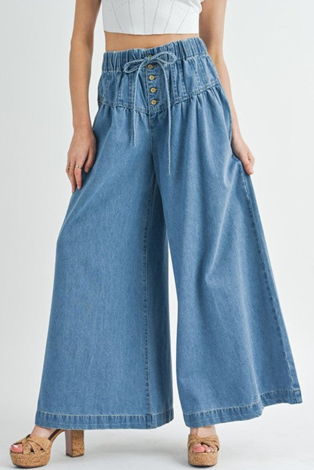 Dusk Blue Mineral Wash Button High Waist Wide Leg JeansMaterial:100%Cotton

• Crafted in a trendy mineral wash, these high waist wide leg jeans exude casual elegance, perfect for a laid-back yet stylish look.
• Featuri