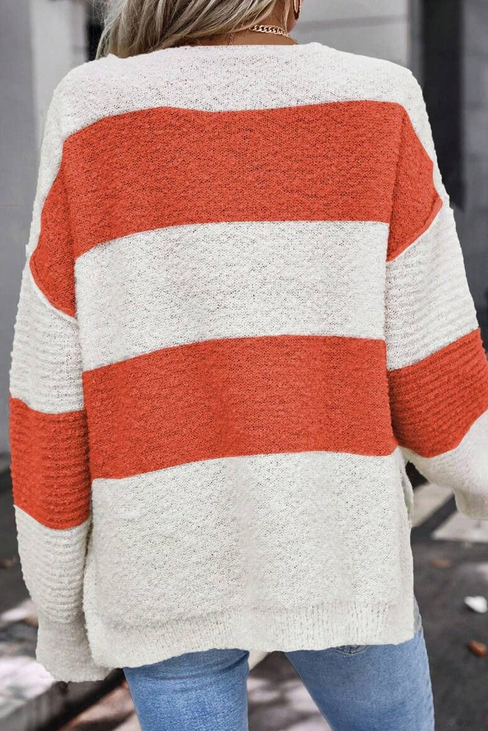 Orange Colorblock V Neck Side Slits SweaterMaterial:100%Acrylic

• Stand out in style with our sweater, blending casual stripes with a trendy rib-knit design.
• The vibrant orange hues add a pop of color to