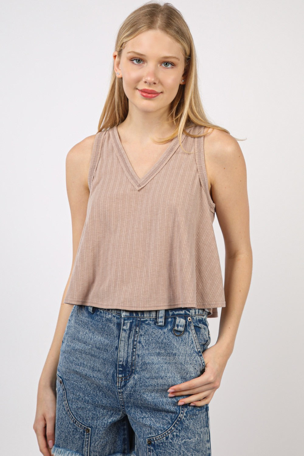 VERY J V-Neck Knit Swing Cropped TankLook effortlessly chic in this Sleeveless Soft Knit Swing Crop Top featuring raw edge detail, designed to add a touch of casual charm to your outfit. This soft girlc