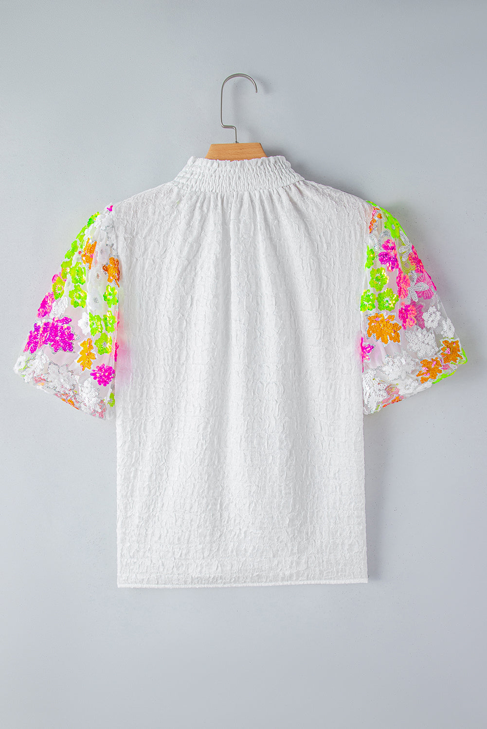 White Smocked Neck Sequin Flower Puff Sleeve Textured TopMaterial:100%Polyester



		The Top features a smocked neckline and sequin flower embellishments for a feminine and glamorous look.
	
	
		With its puff sleeves,