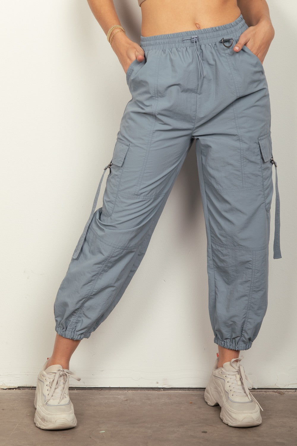 VERY J Elastic Waist Woven Cargo PantsStay on-trend with these Y2K-inspired elastic waist solid woven cargo pants featuring a utility design perfect for everyday wear. The side pockets and D rings add a 