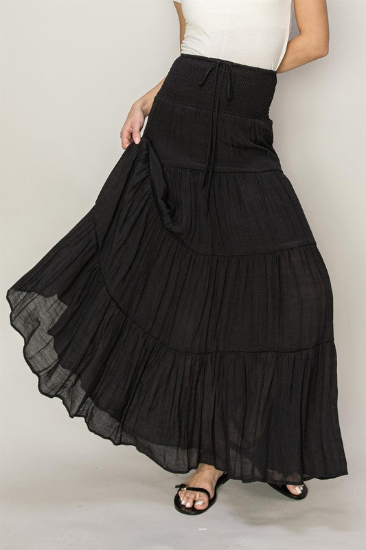 D-Drawstring Waist Tiered Maxi SkirtElevate your warm-weather wardrobe with our D-Drawstring Waist Tiered Maxi Skirt. Crafted to bring a touch of joy to your day, this skirt features a drawstring and s