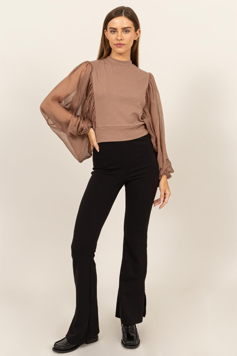 HYFVE Ruched Sheer Long Sleeve Mock Neck BlouseAugment your wardrobe's elegance with this Sheer Sleeve Back Button Blouse. Showcasing delicate sheer sleeves and a sophisticated back button closure, this blouse is