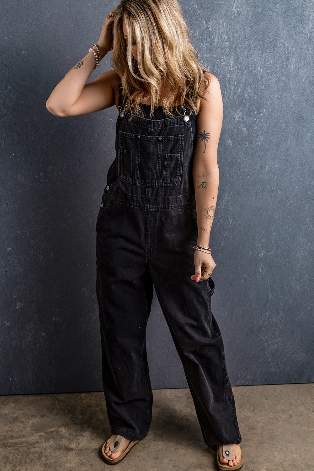 Black Adjustable Buckle Straps Multi Pocket Denim JumpsuitMaterial:65%Cotton+33%Polyester+2%Elastane

• Stylishly versatile, this black denim jumpsuit features adjustable buckle straps for a customized fit that effortlessl