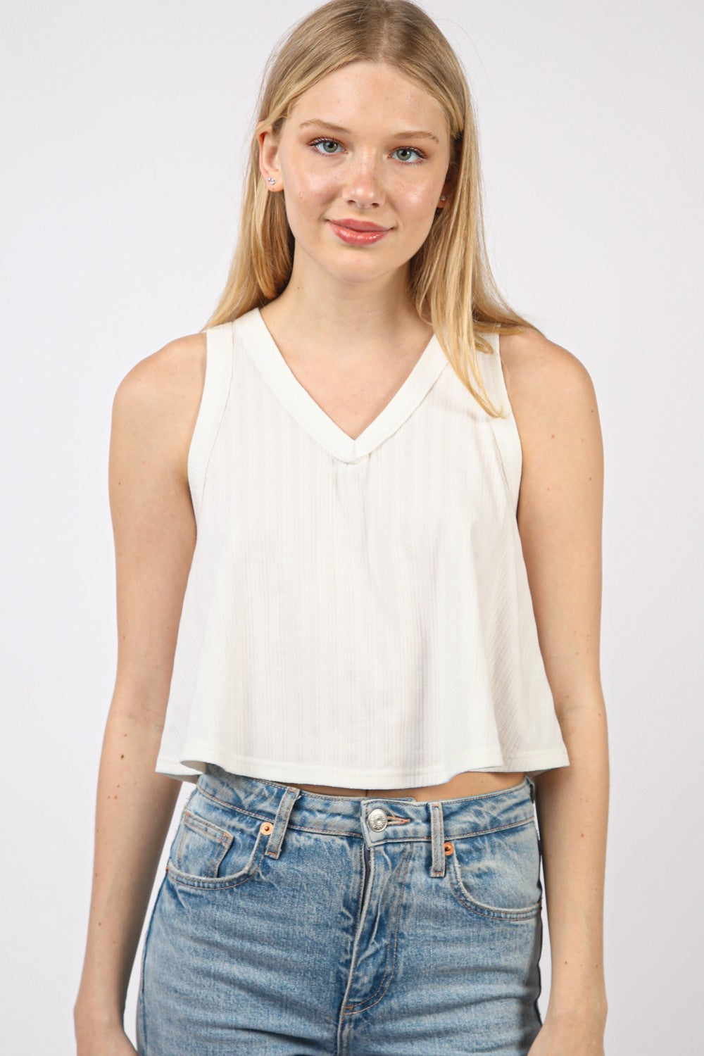 VERY J V-Neck Knit Swing Cropped TankLook effortlessly chic in this Sleeveless Soft Knit Swing Crop Top featuring raw edge detail, designed to add a touch of casual charm to your outfit. This soft girlc