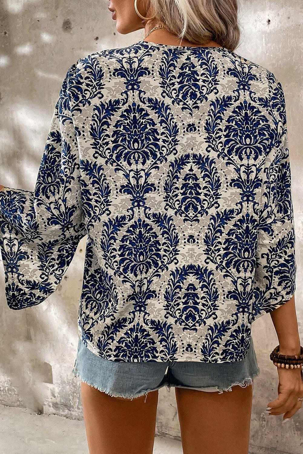 Blue Bohemian Print V Neck Flounce Sleeve BlouseMaterial:100%Polyester



		The three-quarter length sleeves offer a comfortable and stylish fit, perfect for both casual outings and special occasions.
	
	
		S