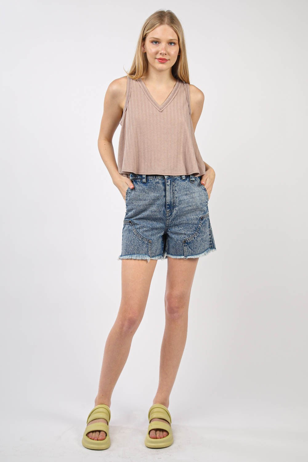 VERY J V-Neck Knit Swing Cropped TankLook effortlessly chic in this Sleeveless Soft Knit Swing Crop Top featuring raw edge detail, designed to add a touch of casual charm to your outfit. This soft girlc