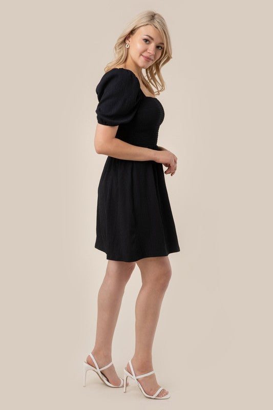 Puff sleeved smocked dress- Puff sleeved smocked dress- Pattern type : solid- Neck line : square neck- Sleeve type : puff sleeves- Sleeve length : short sleeves- Stretch : stretch- Sheer : no