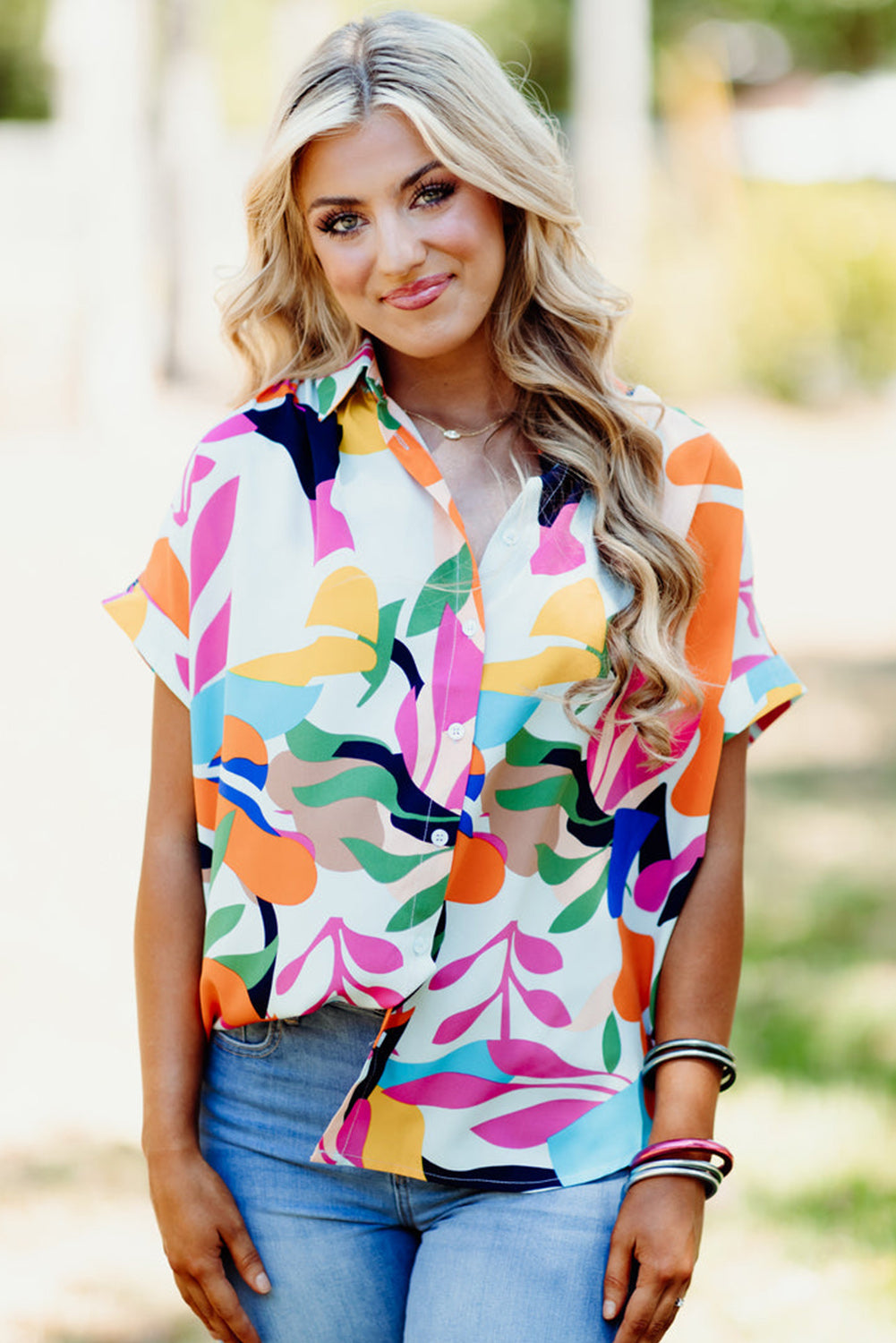 Multicolour Abstract Leaf Print Button Up Short Sleeve BlouseMaterial:100%Polyester

• Infuse your wardrobe with vibrancy in this blouse, perfect for a relaxed yet stylish look.
• The button-up design adds a touch of sophist