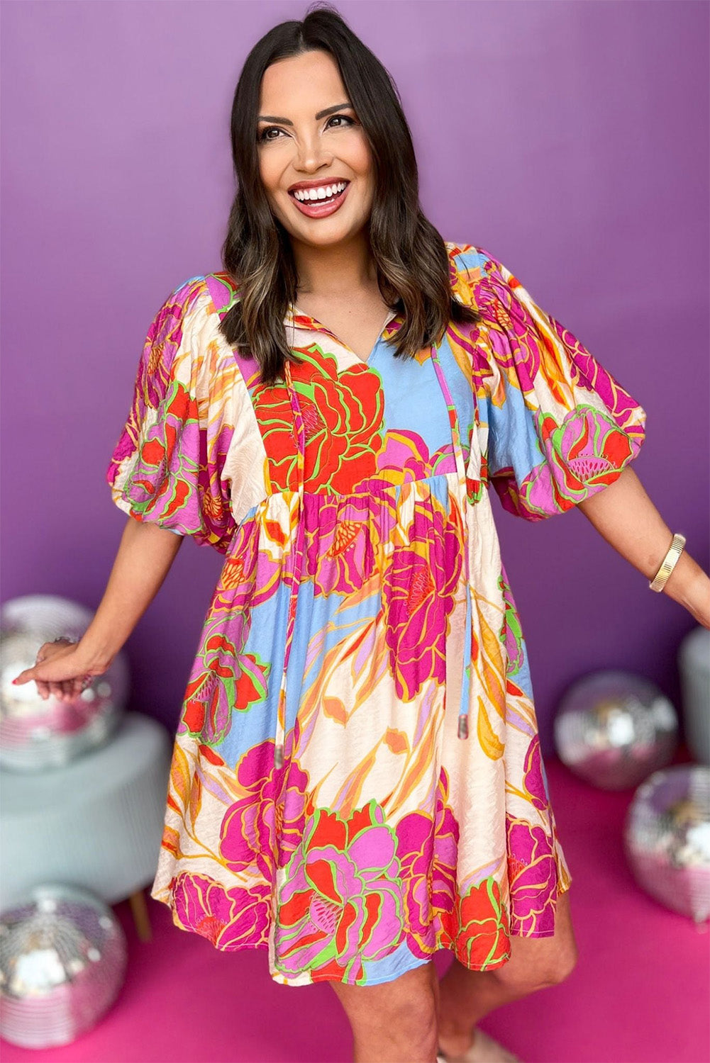 White Puff Sleeve Tied Split Neck Colorful Floral Flowy DressMaterial:100%Cotton


	


		Step into elegance with our mini dress, a vibrant and feminine piece designed to make a statement.
	
	
		This dress features charm